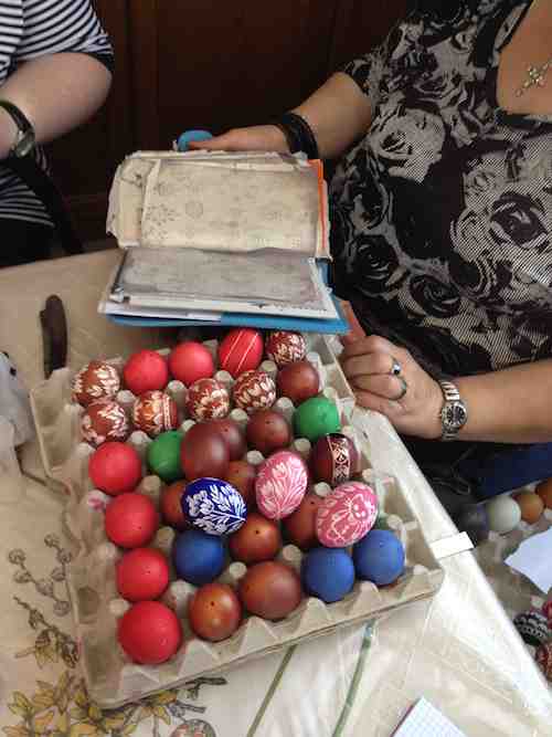 dyed eggs ready to be scratched next to Frau Stipsits' pattern sketchbook