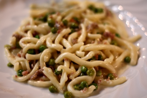 Strozzapreti with peas, ham, and cream sauce